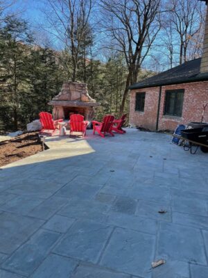 outdoor fireplace kit with red adirondack chairs