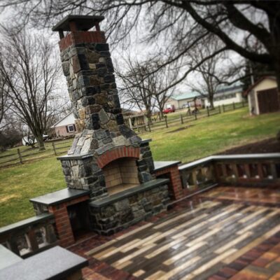 Outdoor fireplace with brick accents