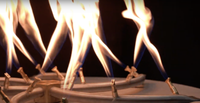 A hybrid stainless bullet burner in action with lots of flame